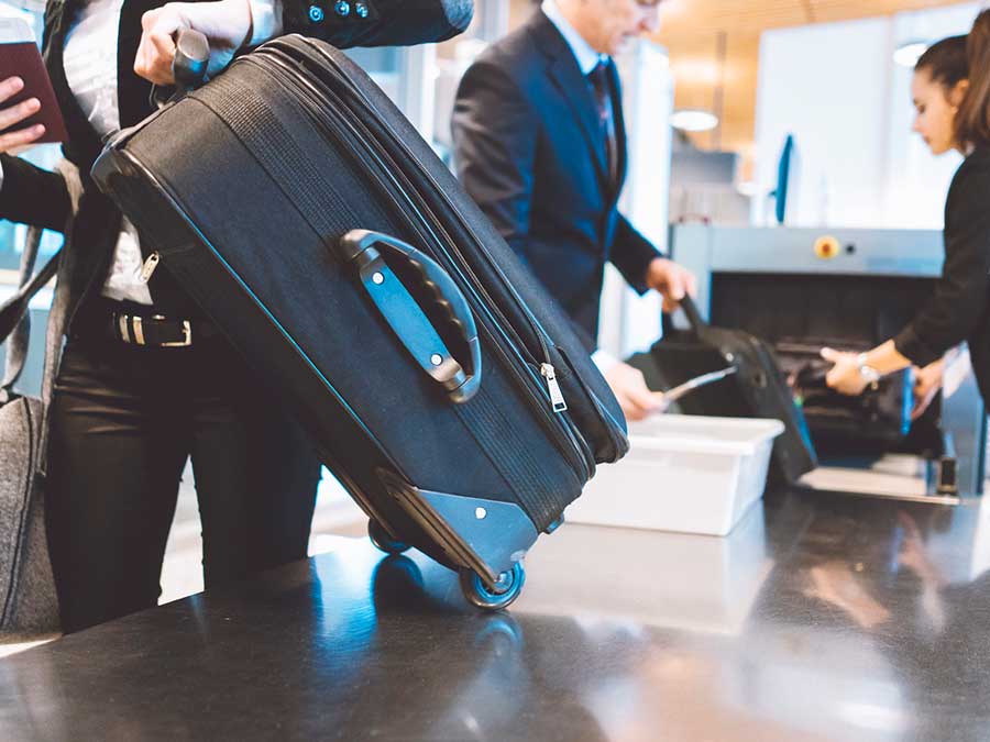 Suitcase going through the xray scanner