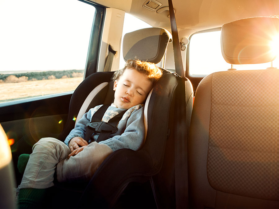 Toddler sleeping in a car seat