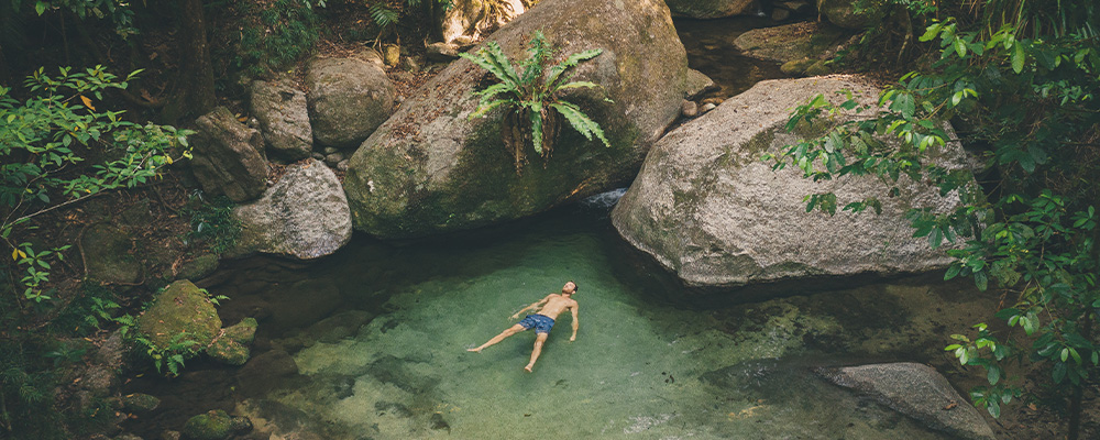 Mossman Gorge man floating in water